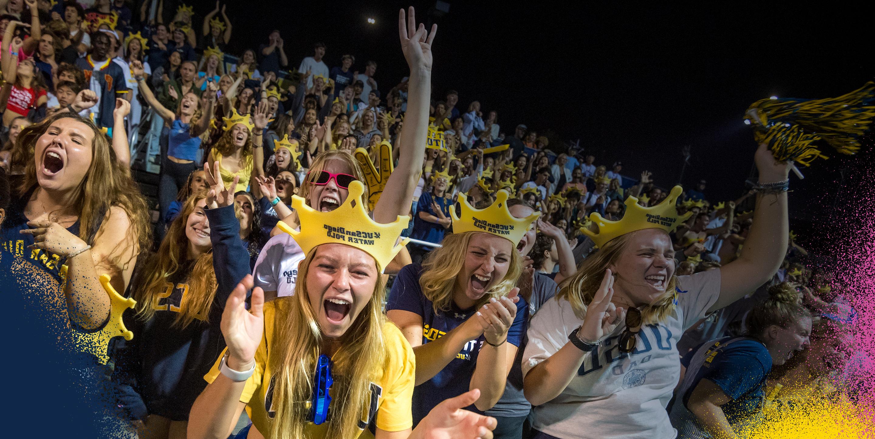 Students cheering in a crowd at a water polo game.